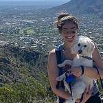 Woman hiking with dog and mountain view